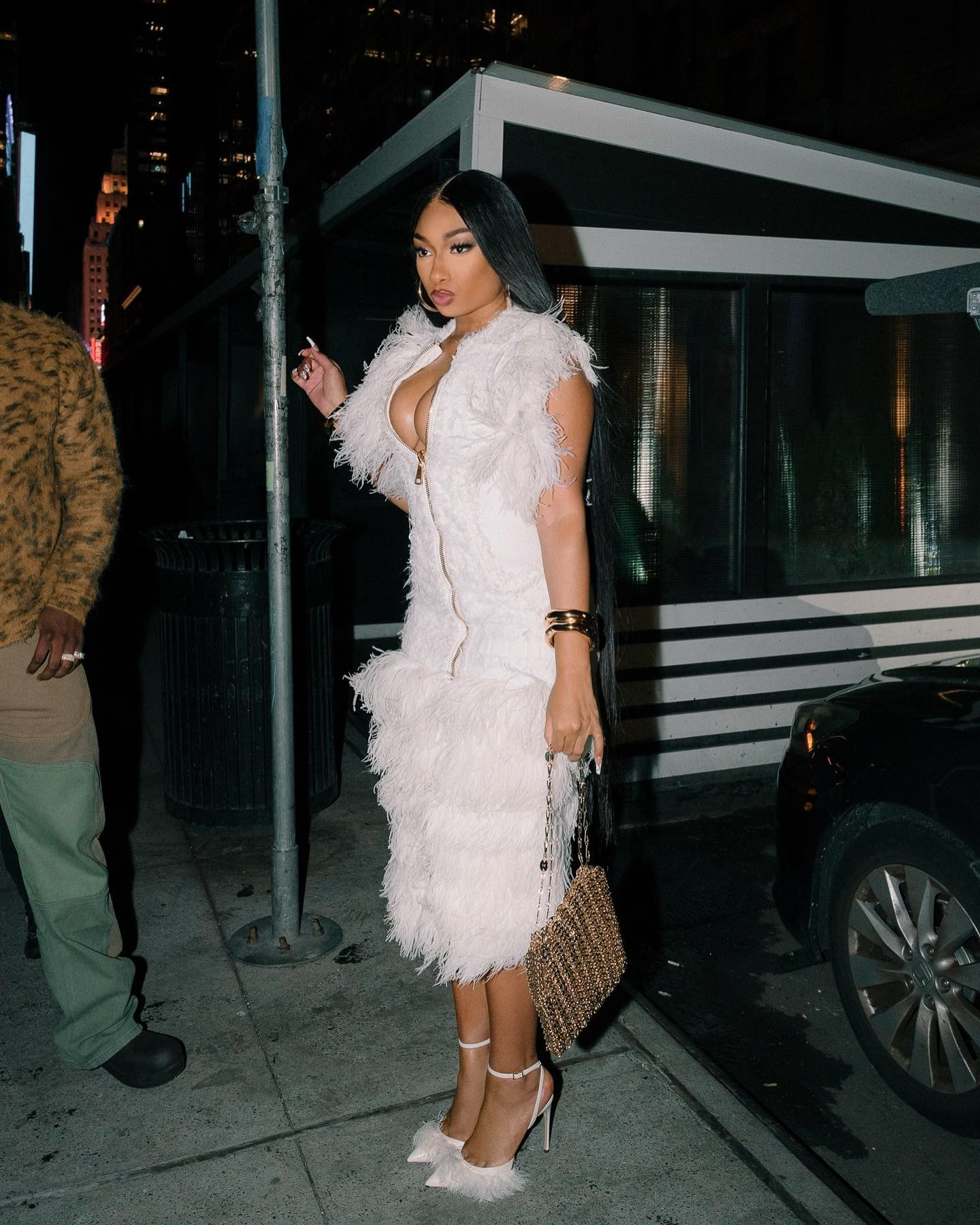 In a Luxurious White Feathered Dress with Chic Accessories